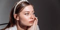 Portrait of a confident young woman with a pearl hairpin. The concept of diversity.