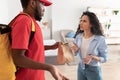 Portrait of confused angry woman complaining about bad food delivery Royalty Free Stock Photo