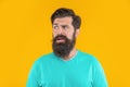 portrait of confused bearded man isolated on yellow. portrait of bearded man in studio. Royalty Free Stock Photo