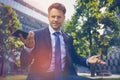 Portrait of confused businessman holding mobile phone