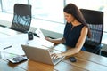 Portrait of a Confused Businesswoman which Works With Papers in Royalty Free Stock Photo