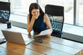 Portrait of a Confused Businesswoman which Works With Papers in Royalty Free Stock Photo