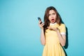 Portrait of a confused cute girl in dress pointing Royalty Free Stock Photo