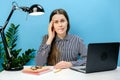Portrait of confused disappointed troubled secretary employee woman in shirt sit work at white office desk with pc laptop prop up