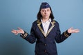 Portrait of confused flight attendant showing unsure gesture Royalty Free Stock Photo