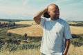 Portrait of confused male farmer looking into the camera and scratching his head. Close up of young doubtful man standing in the Royalty Free Stock Photo