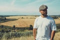 Portrait of confused male farmer looking into the camera and scratching his head. Close up of young doubtful man standing in the Royalty Free Stock Photo