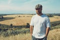 Portrait of confused male farmer looking into the camera and scratching his head. Close up of young doubtful man standing in the Royalty Free Stock Photo