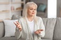 Portrait of confused mature woman talking at camera gesturing Royalty Free Stock Photo