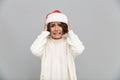 Portrait of a confused puzzled girl in christmas hat Royalty Free Stock Photo