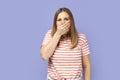 Confused shocked woman covering her mouth with palm, don& x27;t tell a secret to anyone. Royalty Free Stock Photo