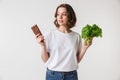 Portrait of a confused young woman holding chocolate bar Royalty Free Stock Photo