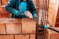 Portrait of Construction worker bricklayer using bricks and mortar for building walls. Royalty Free Stock Photo