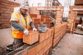 Portrait of Construction worker bricklayer using bricks and mortar for building walls Royalty Free Stock Photo