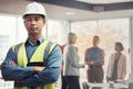 Portrait, construction worker and building with a man engineer standing arms folded in an architecture office Royalty Free Stock Photo