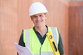 Portrait Of Construction Worker On Building Site With House Plan Royalty Free Stock Photo