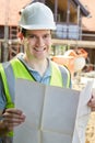 Portrait Of Construction Worker On Building Site Looking At House Plans Royalty Free Stock Photo