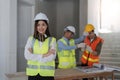 Portrait, construction worker and building with a woman engineer standing arms folded at site work Royalty Free Stock Photo