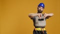 Portrait of construction worker giving thumbs down in studio Royalty Free Stock Photo