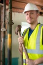 Portrait Of Construction Worker With Sledgehammer Demolishing Wall In Renovated House Royalty Free Stock Photo