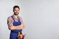 Portrait of construction worker with tool belt on light background Royalty Free Stock Photo