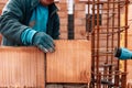 Portrait of Construction worker using bricks mortar and rubber hammer for building walls. Royalty Free Stock Photo