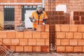 industry details - industrial bricklayer installing bricks on construction site