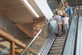 Family with Two Kids Going Down Escalator Royalty Free Stock Photo