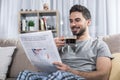 Glad man relaxing with newspaper