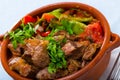 Cooked gyuvech dish of bulgarian cuisine of beef with vegetables at clay pot Royalty Free Stock Photo