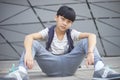 Portrait of cool Asian kid posing outdoors