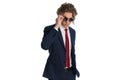 Cool fashion man in suit with hand in pocket wearing and adjusting sunglasses Royalty Free Stock Photo