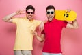 Portrait of a cool gay male couple showing peace gesture Royalty Free Stock Photo