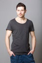 Cool male fashion model against gray background Royalty Free Stock Photo