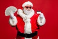 Portrait of cool rich elderly santa hipster millionaire want buy present gift pay with debit card wear white eyeglasses