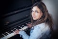 Portrait of cool teenage girl playing the piano Royalty Free Stock Photo