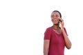 Cool young african woman talking on cell phone and smiling on white background Royalty Free Stock Photo