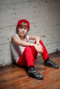 Portrait of cool young hip hop boy in red hat and red pants Royalty Free Stock Photo