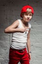 Portrait of cool young hip hop boy in red hat and red pants Royalty Free Stock Photo