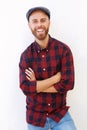 Cool young man with hat smiling against white background Royalty Free Stock Photo