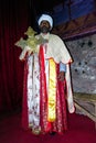 Portrait of coptic orthodox christian priest with big cross inside rock-hewn church Biete mariam at Lalibela, Ethiopia