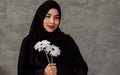 Portrait with copy space adult beautiful muslim woman wearing black headscarf, traditional dress, smiling with happiness, holding Royalty Free Stock Photo