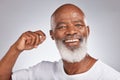 Portrait, cotton and a black man cleaning his ear in studio on a gray background for hygiene or grooming. Earbud, face