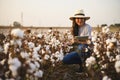 Portrait Cotton farmer woman checks the field with tablet.