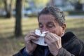 Portrait of a coughing senior man outdoors, looking down Royalty Free Stock Photo