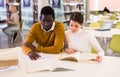 Portrait of couple of adult students studying together in public library Royalty Free Stock Photo