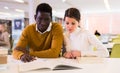 Portrait of couple of adult students studying together in public library Royalty Free Stock Photo