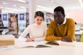 Portrait of couple of adult students studying together in public library Royalty Free Stock Photo