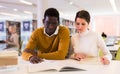 Portrait of couple of adult students studying together in public library Royalty Free Stock Photo