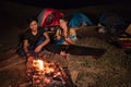 Portrait couple camping, enjoy the night with guitar a sing a so Royalty Free Stock Photo